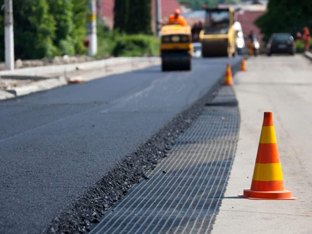 Paving contractors working on one side of the road